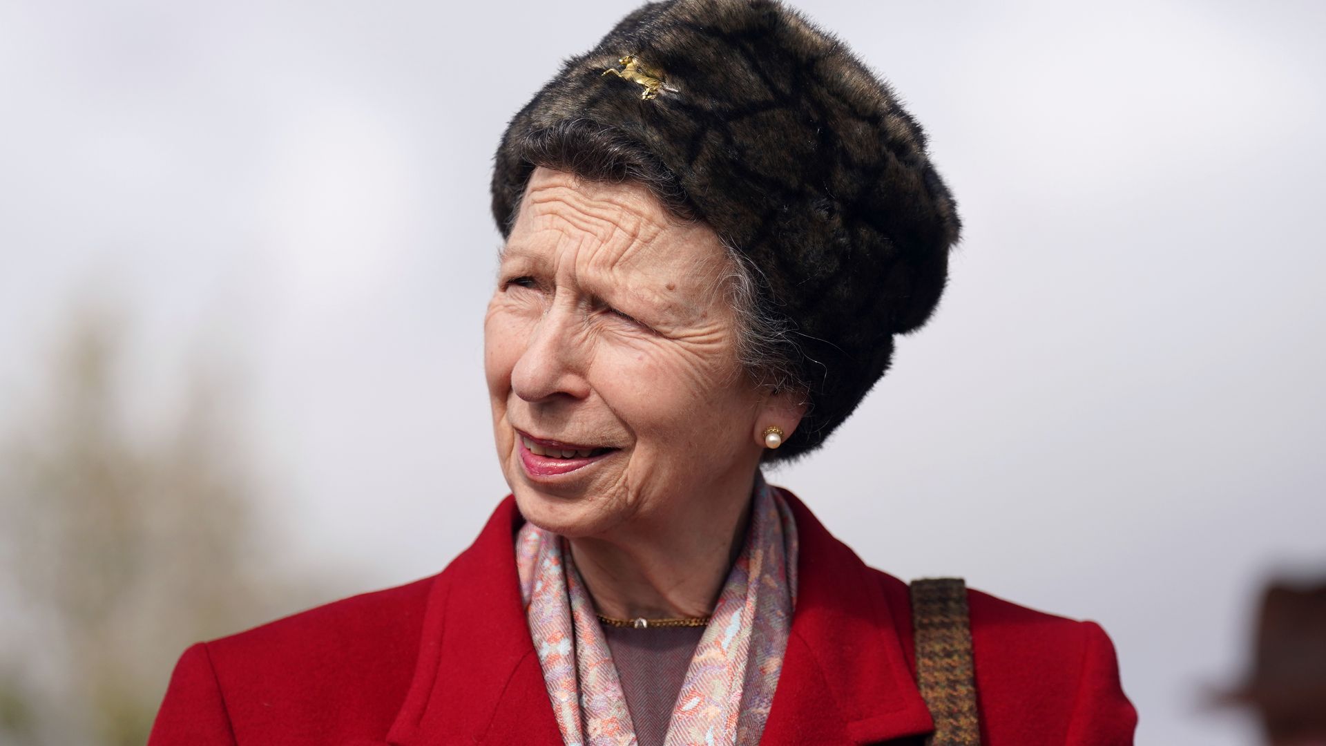 Princess Anne serves 80s fashion with structured shoulder pads and suede boots