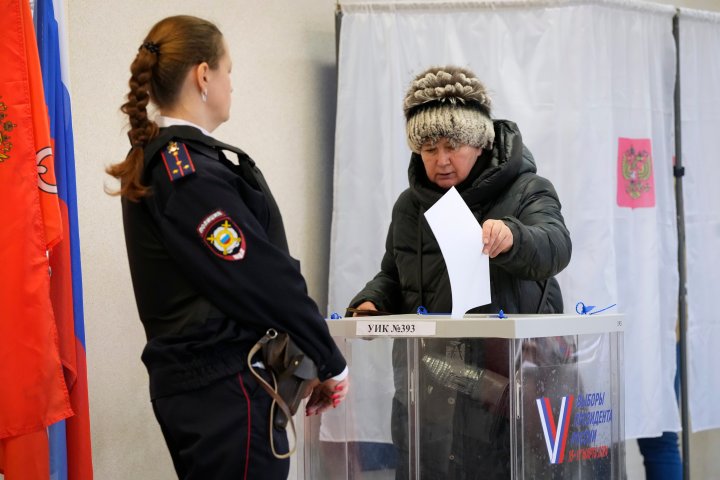 Russians cast ballots in an election preordained to extend Putin’s rule