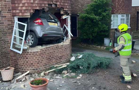 Incredible photos show car completely inside UK home after crashing through window