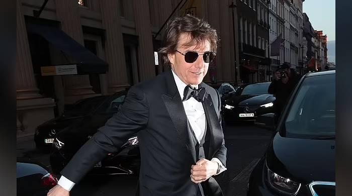 Tom Cruise in good spirits surrounded by fans outside Victoria Beckham’s birthday bash