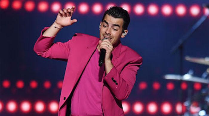 Joe Jonas heads in chic pink alongside Alexandra Kolansinski at Monaco Grand Prix