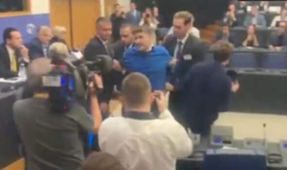 Moment protester lashes out at country leader for ‘selling out to Putin’ in EU Parliament