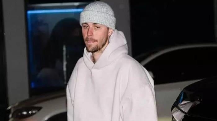 Justin Bieber pokes fun at himself: ‘still standing on business’