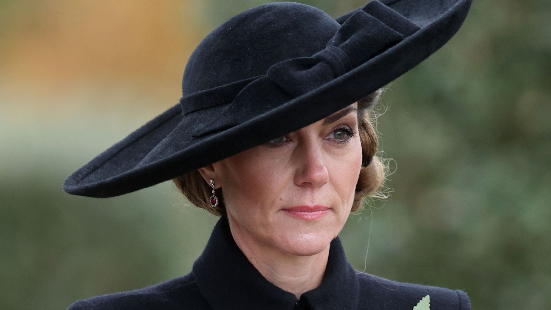 Solemn Princess Kate looks windswept in fringed dress and largest hat of 2025