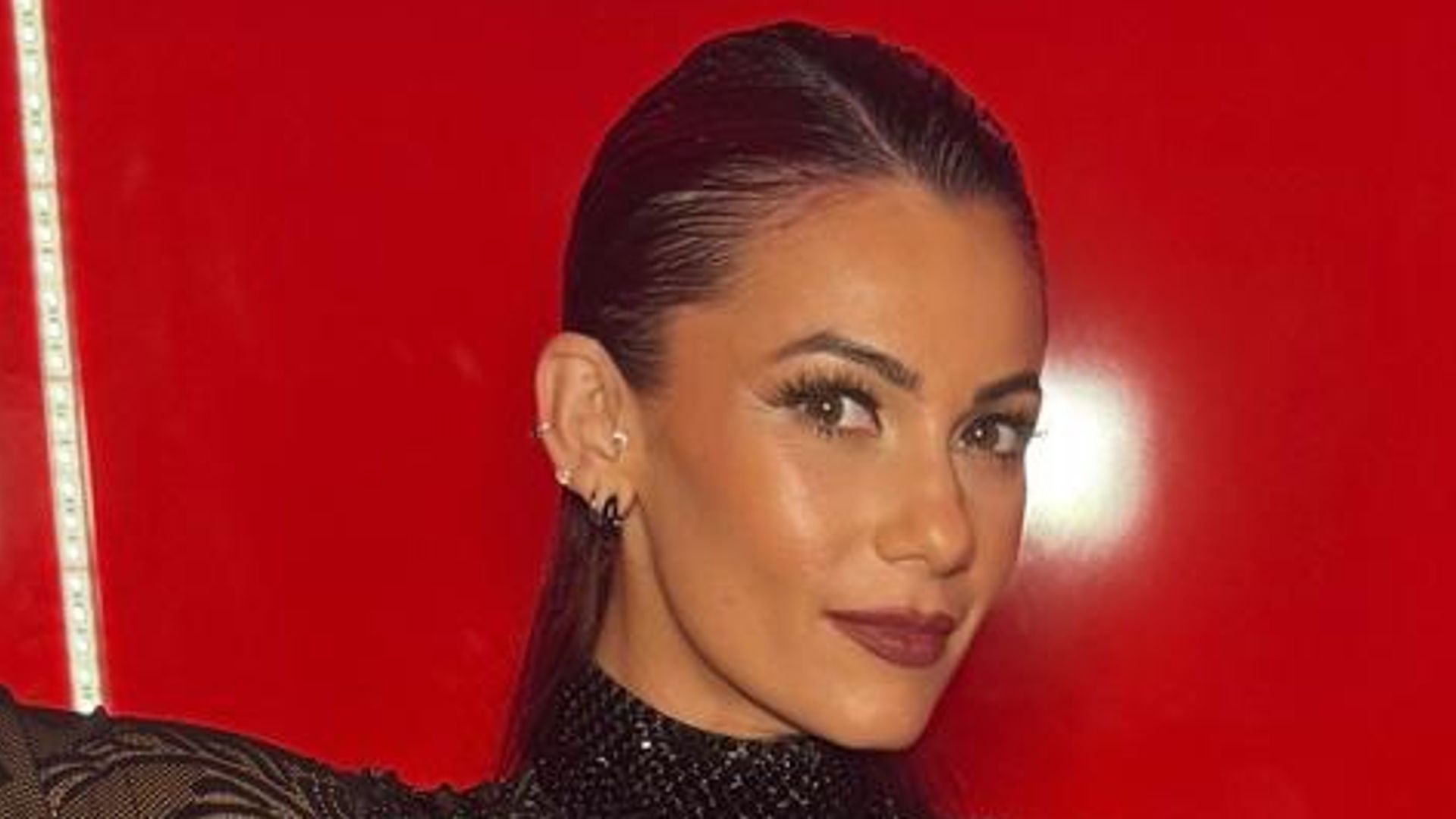 Dianne Buswell displays baby bump in sheer catsuit: ‘He’s certainly grown’