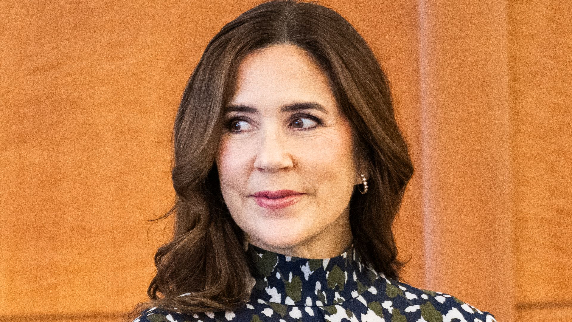 Queen Mary of Denmark’s hair looks lighter than ever as she poses in silky leopard print skirt