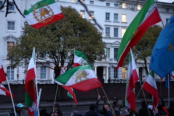 Protester climbs Embassy in London as thousands take to the streets in Iran
