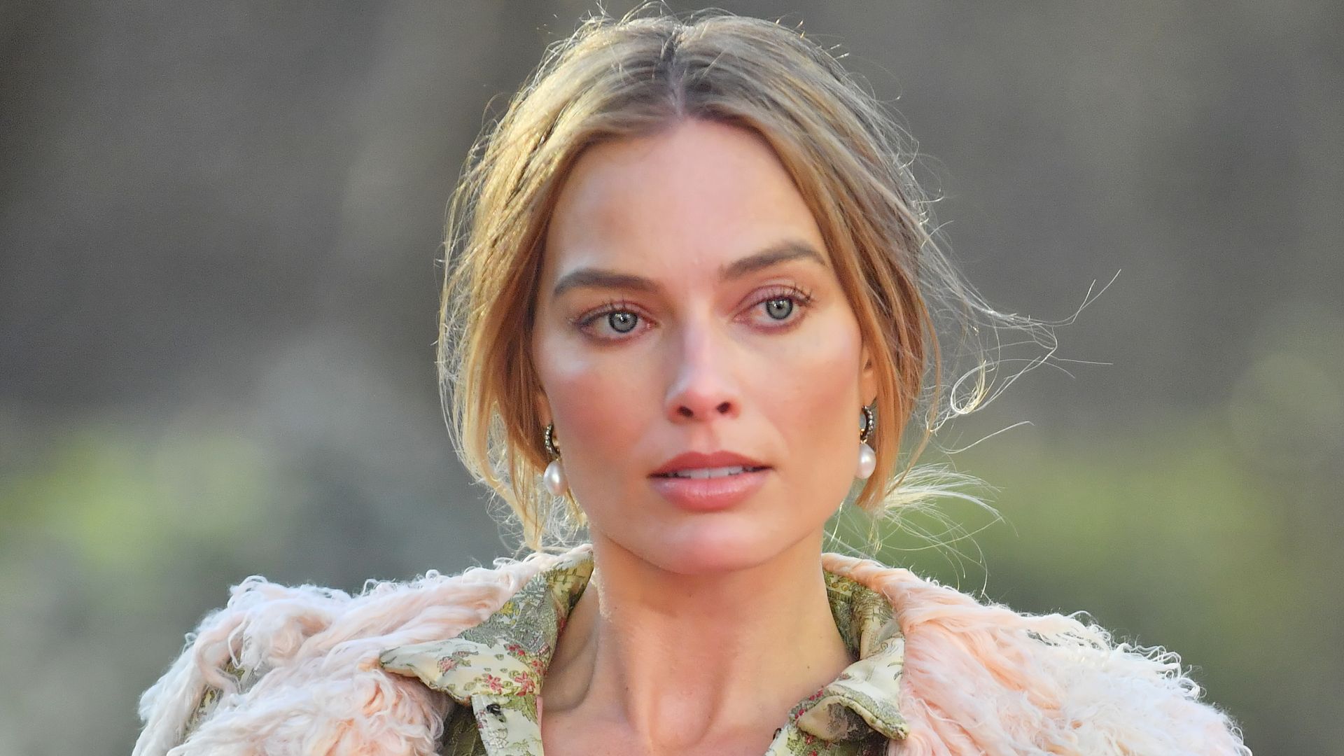 Margot Robbie braves the freezing UK weather in risqué ‘naked’ corset