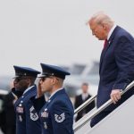 Donald Trump looks ashen-faced as he welcomes home bodies of six dead soldiers