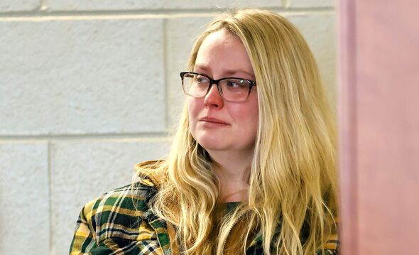 Female police officer accused of repeatedly raping adopted son sobs in court