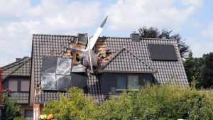 Horror as plane crashes into house with wing hanging out of roof