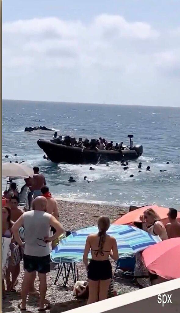 Migrants storm popular tourist beach in front of stunned holidaymakers