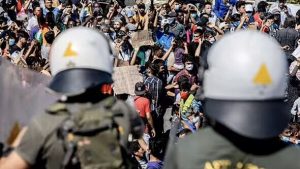 Migrants throw stones and brawl with police during ‘riot’