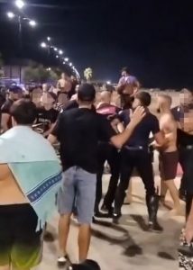 Violent brawl erupts as beachgoers slug it out with deckchairs and wooden crates
