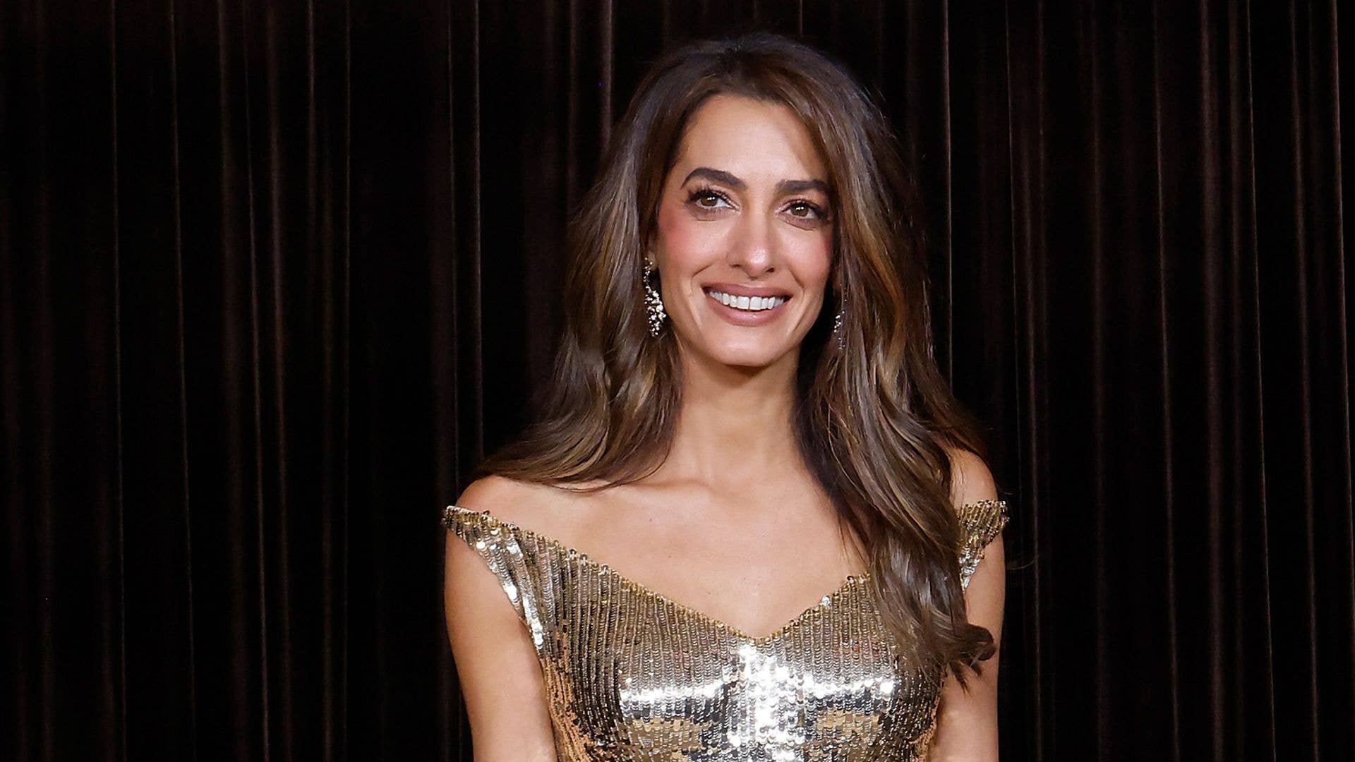 Amal Clooney is a luminous goddess in glittering gold gown alongside husband George at The Albies